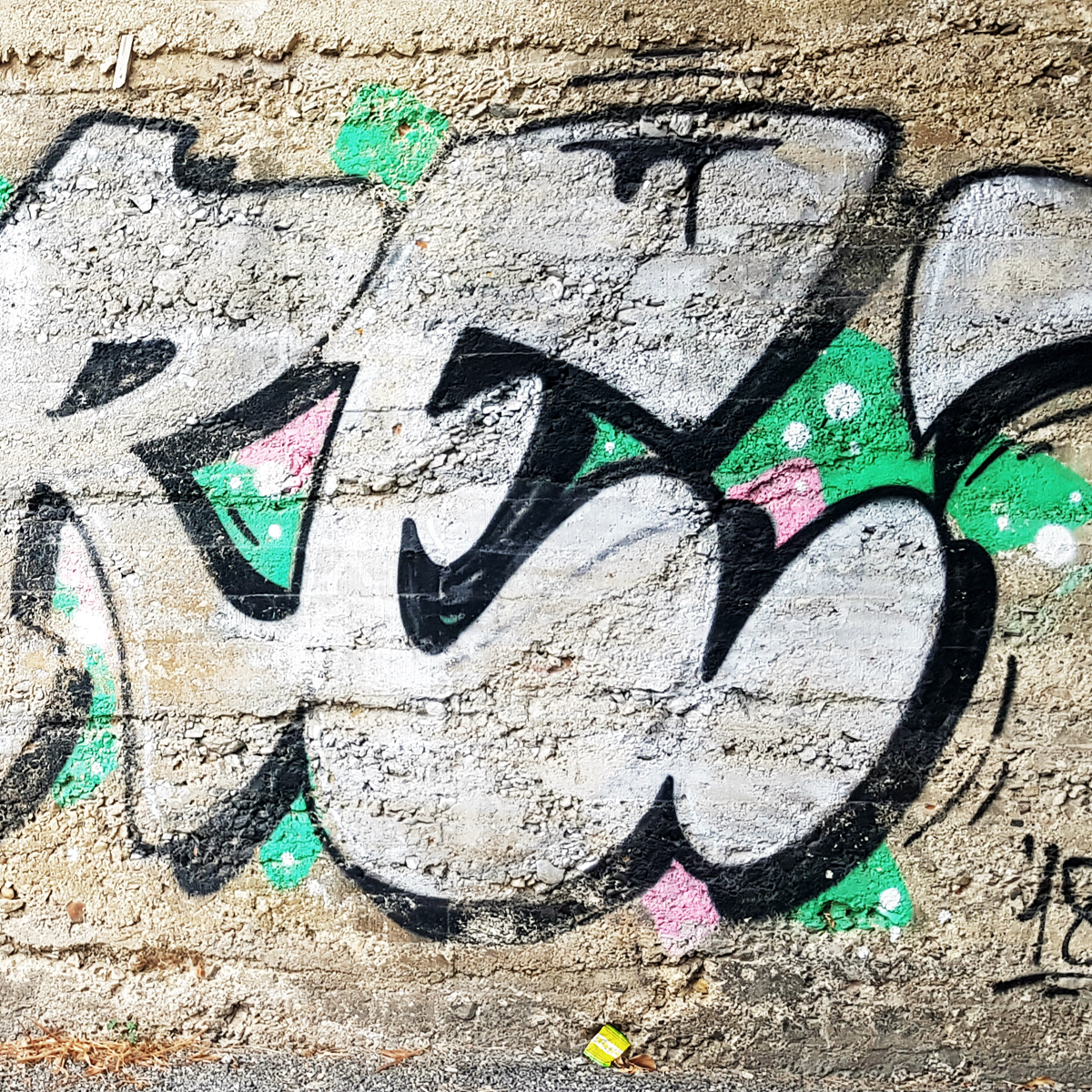 graffiti on a wall with a large capital E