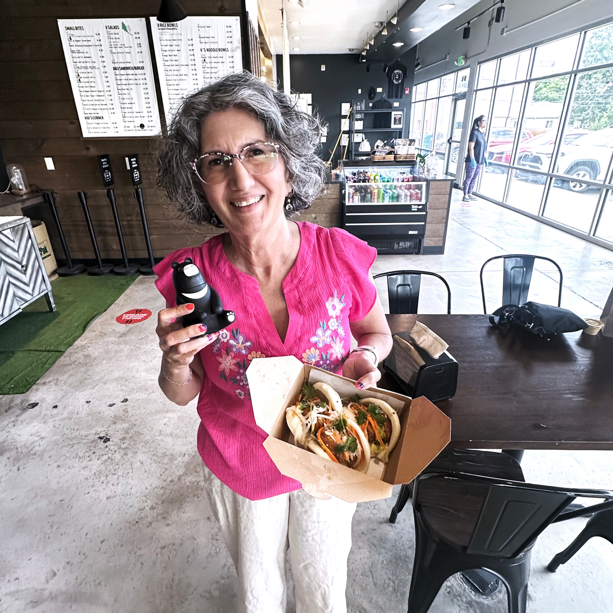 woman holding up a plate of vegan food