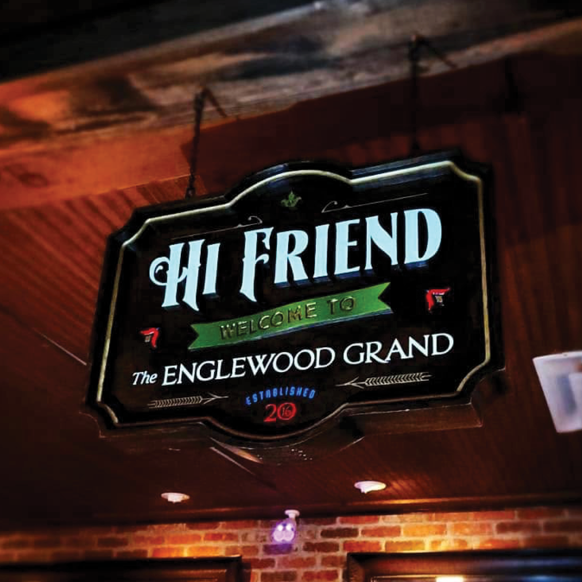a hand-made sign hanging above the bar counter with the text: Hi Friend